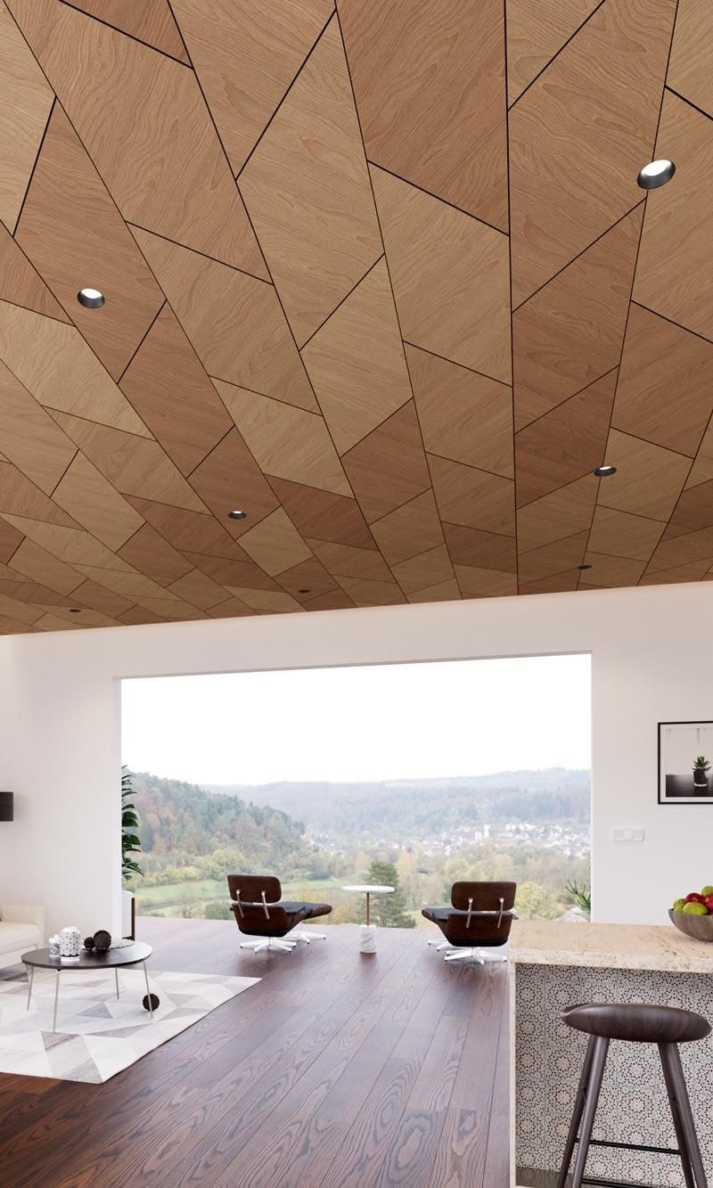 Modern living room with a stunning geometric ceiling design illuminated by DMF Lighting recessed fixtures, enhancing the architectural details.